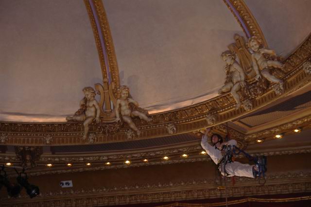 Inspecting plaster ceiling in theater